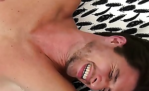 Bed pressed handsome guy gets feet disciplined with feathers