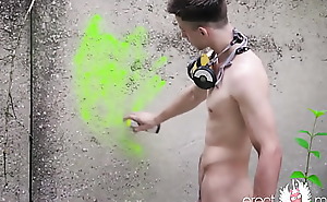 Naked teen boy with soft to hard dick draws bright graffiti outdoor